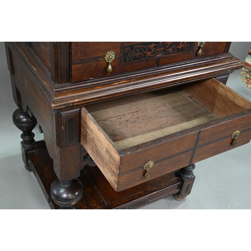 946 - An antique oak, walnut and marquetry book press, with two frieze drawers, raised on four bulbous sup... 