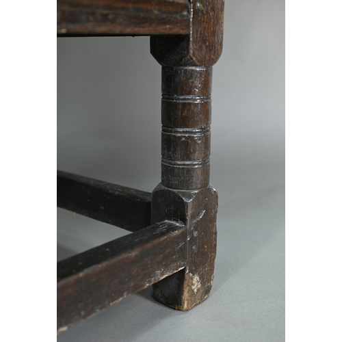 947 - A Charles I jointed oak box-seat table-chair, circa 1640, having a pivotal boarded top/back with cle... 