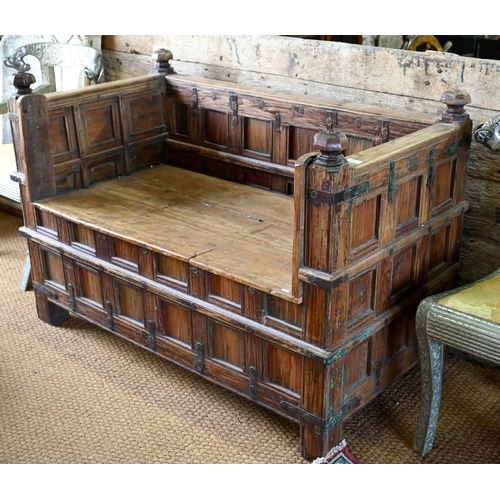 948 - An old Indian iron bound teak box seat settle/bench, the patinated surface finish including traces o... 