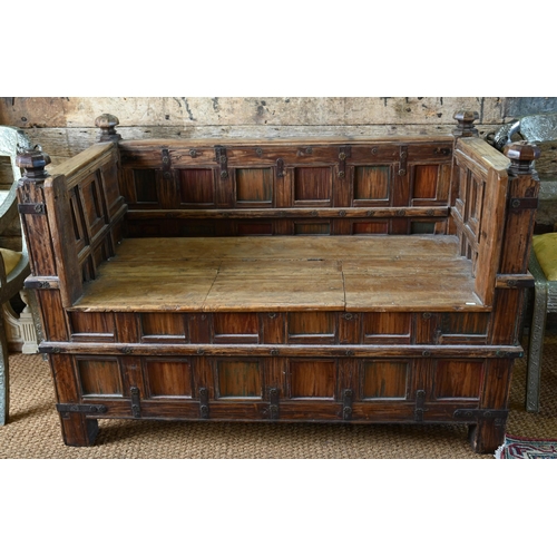 948 - An old Indian iron bound teak box seat settle/bench, the patinated surface finish including traces o... 