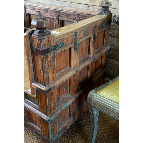 948 - An old Indian iron bound teak box seat settle/bench, the patinated surface finish including traces o... 