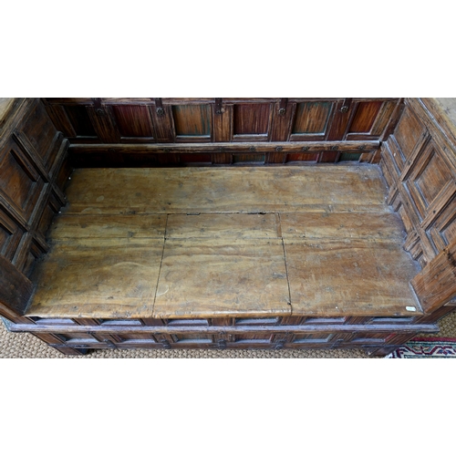 948 - An old Indian iron bound teak box seat settle/bench, the patinated surface finish including traces o... 