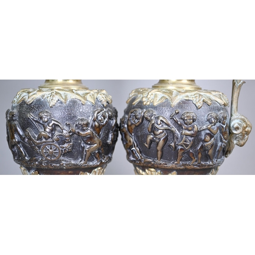 959 - A pair of 19th century Continental brass and bronze garniture ewers in the Renaissance manner, the s... 