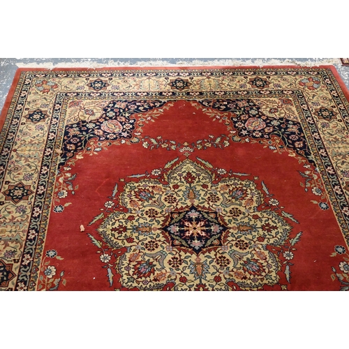 835 - An old Persian Indo Persian Saruk carpet, the deep pink ground centred by a floral medallion, 390 cm... 