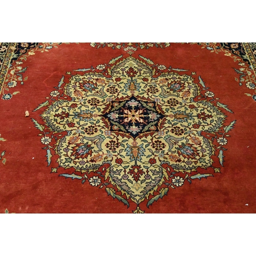 835 - An old Persian Indo Persian Saruk carpet, the deep pink ground centred by a floral medallion, 390 cm... 