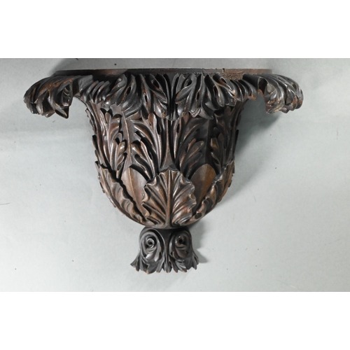 847 - A trio of carved hardwood wall brackets, one large 27 cm high, two 24 cm high, all a/f (3)