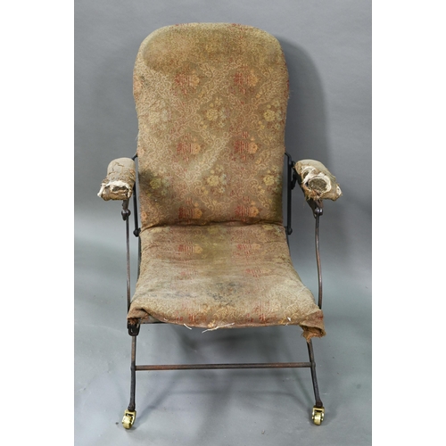 927 - A Victorian folding iron-framed campaign armchair with remnants of original upholstery fabric, the f... 