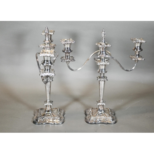 10A - A pair of ep three branch candelabra in the rococo manner with three candle holders, detachable cent... 