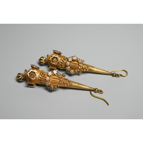 233 - A pair of Victorian textured yellow metal pear-shaped drop earrings with star and foliate motifs, wi... 