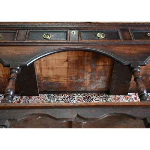 925 - An antique oak low dresser with three double moulded front drawers over a triple arched apron, raise... 