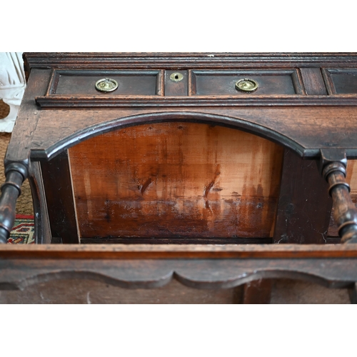 925 - An antique oak low dresser with three double moulded front drawers over a triple arched apron, raise... 