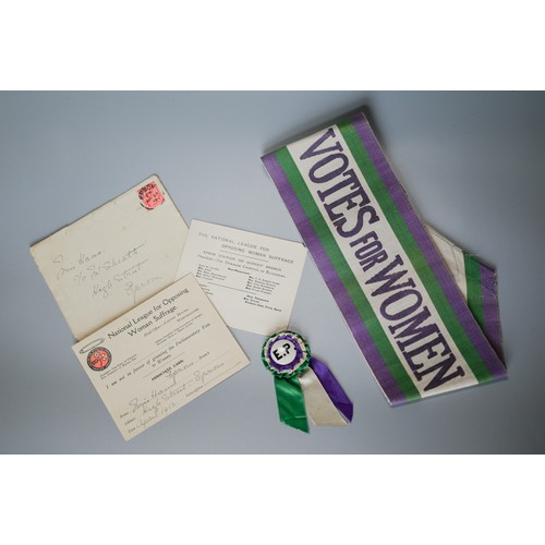 An original 'Votes for Women' tri-coloured Suffragette sash woven in purple, green and white, with blue printed inscription, 55 cm long x 10 cm wide, to/w a rosette with central enamel badge with E. P. initials (possibly for Emmeline Pankhurst - Suffragette leader) and a National League for Opposing Woman Suffrage associate member card for Miss Hann, dates April 1913 with envelope of posting (3)
