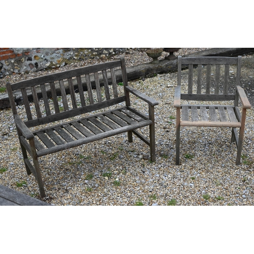 75 - A rectangular weathered teak garden/patio table 150 cm x 90 cm x 72 cm h to/w a two-seater slatted b... 