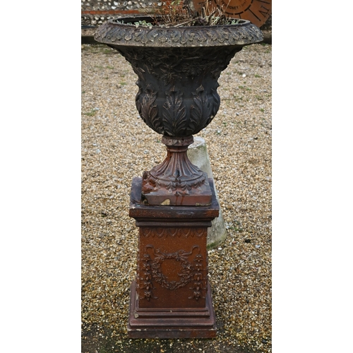 59 - A large weathered classical cast urn on plinth, with patinated teracotta surface finish, on square p... 