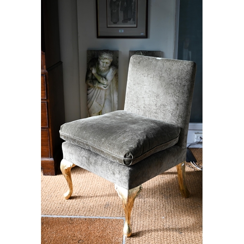 105 - George Smith Ltd, a green fabric upholstered chair with seat cushion, raised on giltwood cabriole fr... 