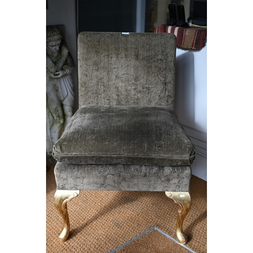 105 - George Smith Ltd, a green fabric upholstered chair with seat cushion, raised on giltwood cabriole fr... 