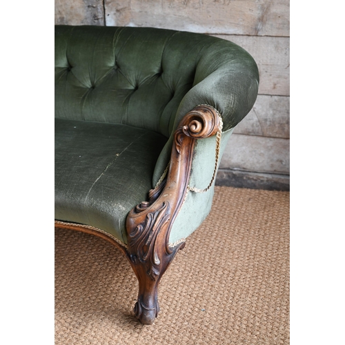 106 - A green button back draylon upholstered Victorian walnut framed serpentine front sofa, on castors. a... 