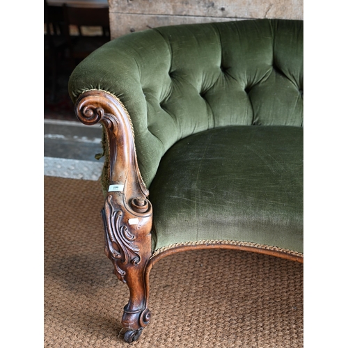 106 - A green button back draylon upholstered Victorian walnut framed serpentine front sofa, on castors. a... 