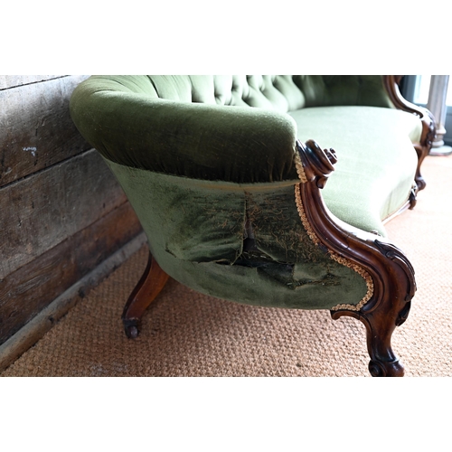 106 - A green button back draylon upholstered Victorian walnut framed serpentine front sofa, on castors. a... 