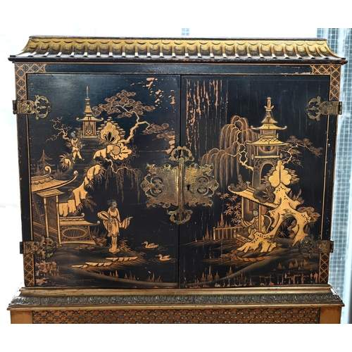 108 - A mid-century Georgian style black Japanned and gilt pictorial cabinet on stand, the twin doors encl... 