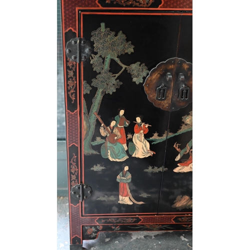 119 - A Japanese black lacquered and polychrome pictorial decorated cabinet, 62 cm x 31 cm x 92 cm h, lock... 