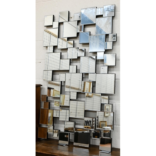 124 - A contemporary wall mirror with multi-bevelled square plates, 140 x 84 cm