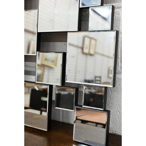 124 - A contemporary wall mirror with multi-bevelled square plates, 140 x 84 cm