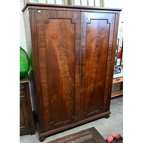 125 - A 19th century mahogany compactum wardrobe with panelled doors enclosing hanging space and five draw... 