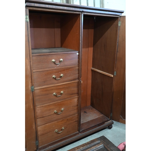 125 - A 19th century mahogany compactum wardrobe with panelled doors enclosing hanging space and five draw... 