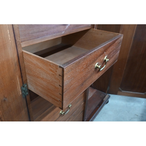 125 - A 19th century mahogany compactum wardrobe with panelled doors enclosing hanging space and five draw... 