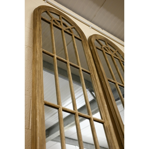 126 - A pair of large arched 'window' mirrors (2)