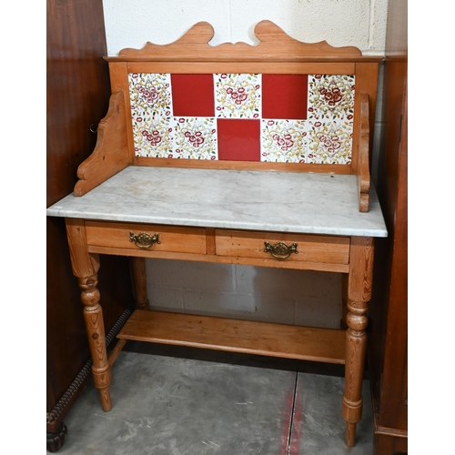 127 - Early 20th century pine marble top wash stand with raised tiled back and two drawers on turned suppo... 