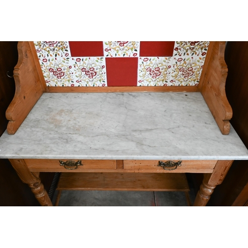 127 - Early 20th century pine marble top wash stand with raised tiled back and two drawers on turned suppo... 