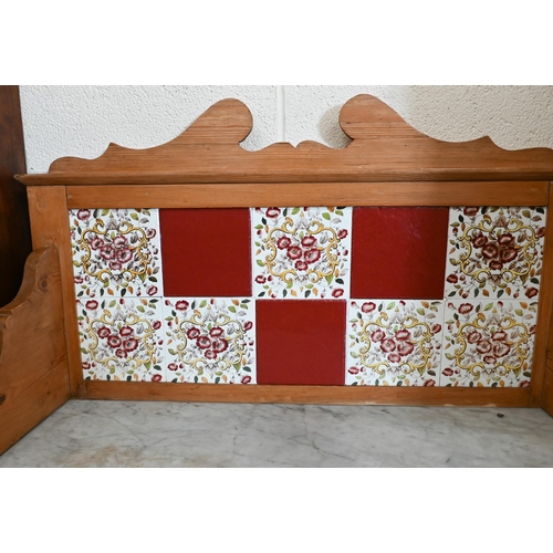 127 - Early 20th century pine marble top wash stand with raised tiled back and two drawers on turned suppo... 