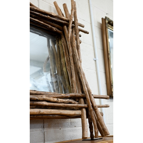 133 - A wall mirror in layered driftwood frame, 100 x 100 cm