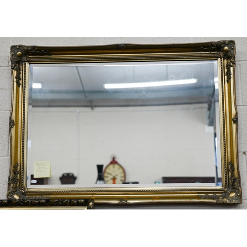 135 - # Two modern rectangular wall mirrors with decorative foliate moulded gilt frames, 120 x 78 cm and 1... 