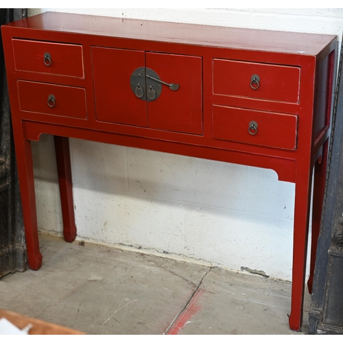 137 - A Chinese red lacquer sidetable with central cupboards and two drawers to each side, with brass fitt... 