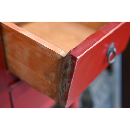 137 - A Chinese red lacquer sidetable with central cupboards and two drawers to each side, with brass fitt... 