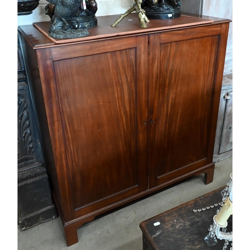 138 - A 19th century mahogany linen press with panelled doors enclosing five slides standing on bracket fe... 