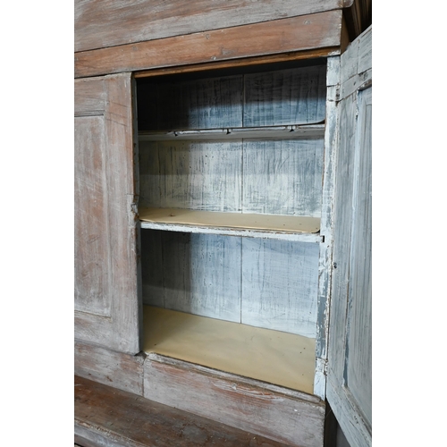 139 - A Continental antique lime washed dresser/kitchen cabinet with panelled doors, 108 cm wide x 44 cm d... 