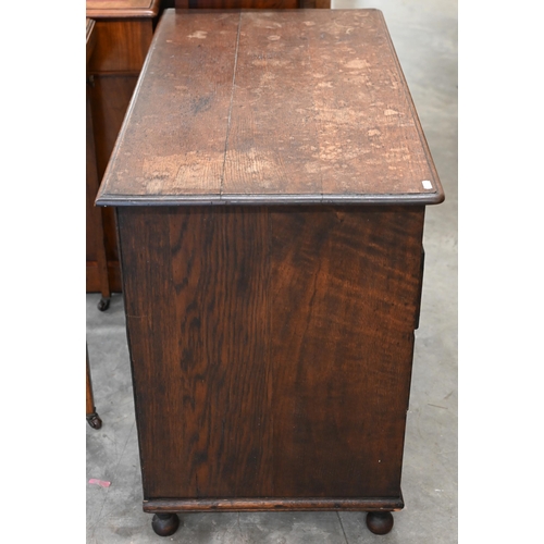 141 - A 19th century Jacobean style oak kneehole desk with eight drawers around the central recessed cupbo... 