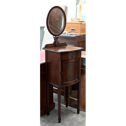 145 - A mahogany vanity stand with adjustable oval mirror, drawer and cupboard on tapering square supports... 