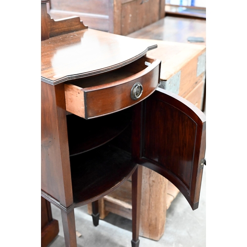 145 - A mahogany vanity stand with adjustable oval mirror, drawer and cupboard on tapering square supports... 