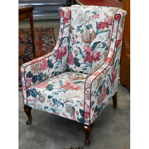 173 - A mahogany framed floral upholstered wingback bedroom chair