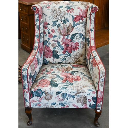 173 - A mahogany framed floral upholstered wingback bedroom chair