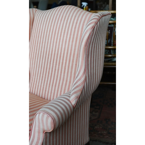 177 - A Georgian style wingback armchair, herringbone striped fabric and moulded mahogany legs