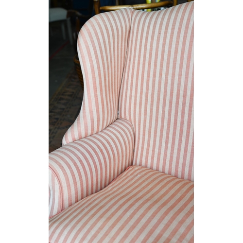 177 - A Georgian style wingback armchair, herringbone striped fabric and moulded mahogany legs