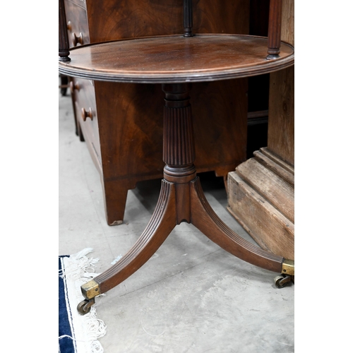 183 - A Georgian mahogany twin-tier circular dumnb waiter on turned and reeded triform base with brass cas... 