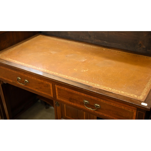 185 - An Edwardian walnut writing table with tooled tan leather top and two frieze drawers, 108 x 54 x 78 ... 