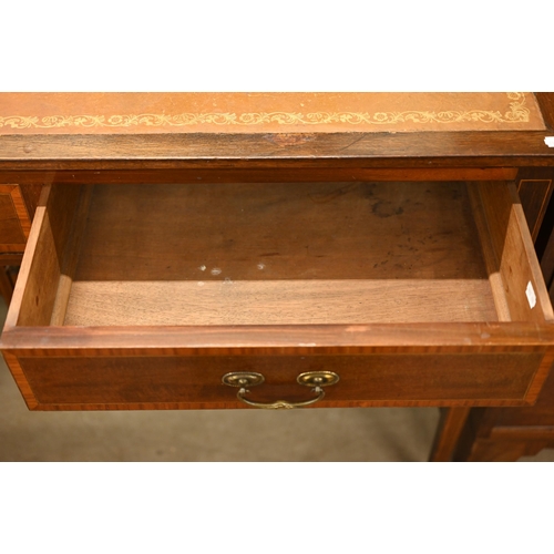 185 - An Edwardian walnut writing table with tooled tan leather top and two frieze drawers, 108 x 54 x 78 ... 